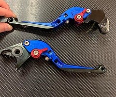 Adjustable folding levers