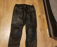 2 pairs leather motorcycle bottoms.