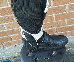 Variety of motocross equipment.
Boots, helmet,chest protector and neck brace.