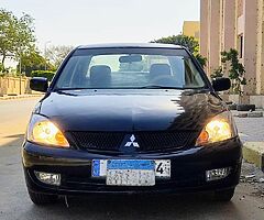 لانسر بومه ٢٠٠٨ اوتوماتيك خليجى كامله رخصه سنه باسمى مرور الدقى عداد ١٧٥ الف - Image 8/10